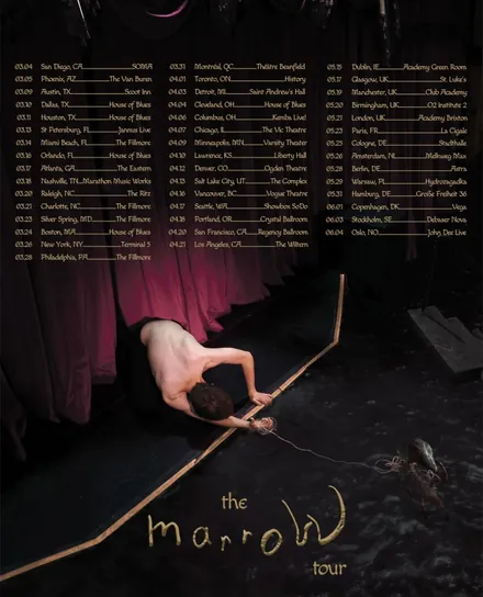 The marroW tour poster: brakence leaning over the edge of a dark stage in front of red curtains